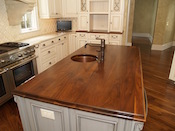Walnut kitchen countertop, wide plank flat grain construction, 1.75” thick, large double roman ogee edge, undermount sink, with permanent finish. This custom walnut wood island countertop was installed in Weddington, NC.